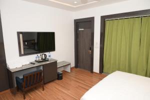 Postel nebo postele na pokoji v ubytování Krishnangan Hotel & Resort + 8 fotografií