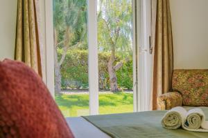 a room with a table and a window with a view at HideAway by MOJE Holiday in Porches +24 photos
