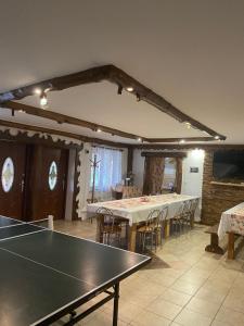 a dining room with a table with at Sosenka in Zalas