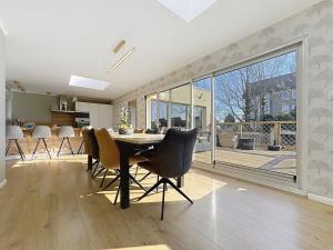 a kitchen and dining room with a table and chairs at Villa - Les vacances à la Mer in Bray-Dunes