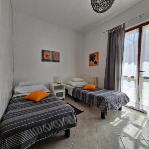 two beds in a room with a window at Lily's lovely apartments in Fažana