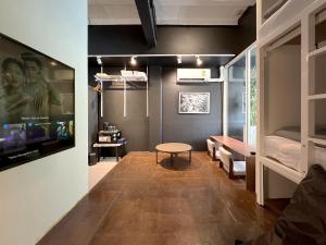 a room with a table and a room with a bed at Chatel Samyan - Self check-in in Bang Rak