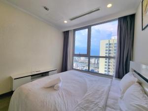 a bedroom with a large bed and a large window at RiverGate Residence in Ho Chi Minh City +40 photos