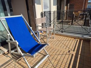 a blue rocking chair sitting on a balcony at Casa Grace - SANTA MONICA in Lido di Jesolo
