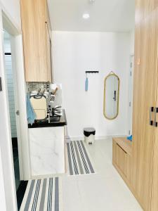 a white bathroom with a sink and a mirror at 302 Modern Studio with Balcony & Kitchen in Ho Chi Minh City