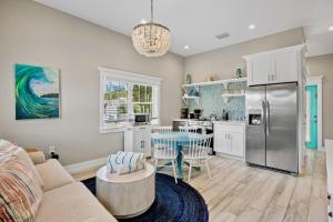 a kitchen and living room with a refrigerator and a table at Villa #4 Sand Dollar in Holmes Beach