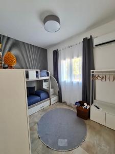 a room with two bunk beds and a blue rug at Elsa Holiday Home in Fontane Bianche +77 photos