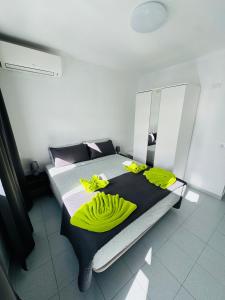 a bedroom with a bed with yellow towels on it at Bungalow Simone in Maspalomas +16 photos
