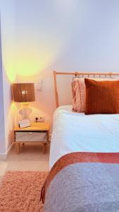 a bedroom with a bed and a table with a lamp at New Calm & Charming Loft Altea in Altea