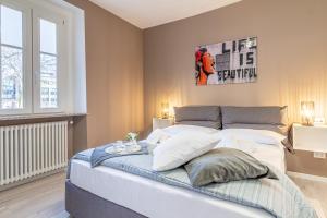 a bedroom with a large bed and a poster on the wall at Isolino Bridge Apartment - Historic Center in Monza