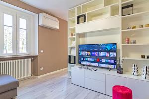 a living room with a large flat screen tv at Isolino Bridge Apartment - Historic Center in Monza