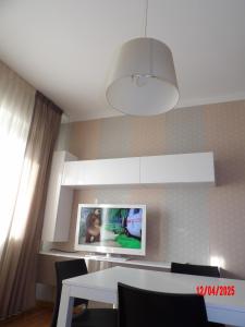 a dining room with a white table and a light at Casa Baia in Pesaro