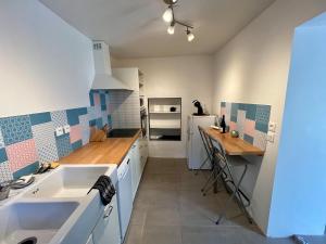 a kitchen with a sink and a counter in it at Charmante maison dans un hameau paisible in Salasc