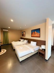Ένα ή περισσότερα κρεβάτια σε δωμάτιο στο Hotel Ompu Herti