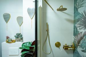 a bathroom with a shower with a mirror on the wall at Almi Aparthotel in Cluj-Napoca +34 photos