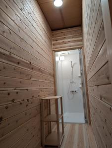 a bathroom with a wooden wall with a ladder in it at Riviera Iya Valley in Akano +44 photos