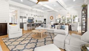 a living room with white furniture and a kitchen at WaterColor Escape in Santa Rosa Beach