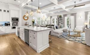 a kitchen with white cabinets and a living room at WaterColor Escape in Santa Rosa Beach