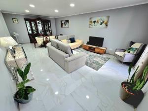 a large living room with couches and a tv at São Brás Home in Porto Formoso