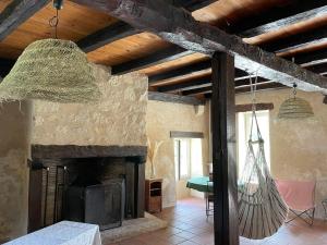a living room with a fireplace and a chandelier at Maison de campagne avec grande piscine in Agonac