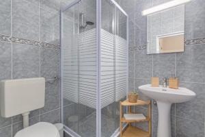 a bathroom with a shower and a toilet and a sink at 4-bedroom Townhouse with Terrace in Center Oldtown in Lagos +53 photos