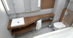 a bathroom with a sink and a toilet and a mirror at Hotel Santa Maria in Saint-Florent