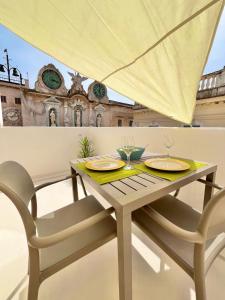 a table with two glasses on top of a building at Casa Garibaldi in Trapani +60 photos