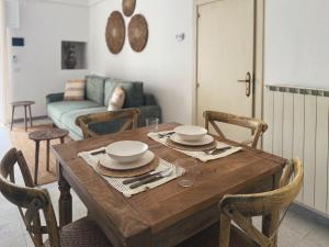 a dining room with a wooden table with chairs at Dimora Pinto in Locorotondo