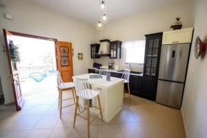 a kitchen with a refrigerator and a table and chairs at Maria's Private Residence in Kalymnos