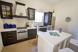 a kitchen with brown cabinets and a white counter top at Maria's Private Residence in Kalymnos +8 photos