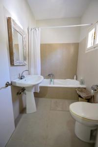a bathroom with a sink and a tub and a toilet at Maria's Private Residence in Kalymnos