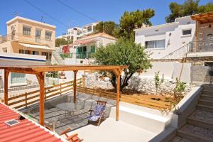 a view from the balcony of a house with a chair at Maria's Private Residence in Kalymnos