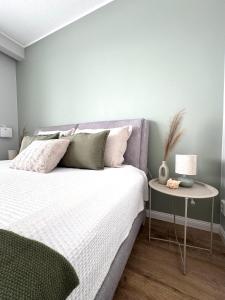 a bedroom with a bed and a side table at Tullikatu Two-Bedroom Apartment in Kristinestad