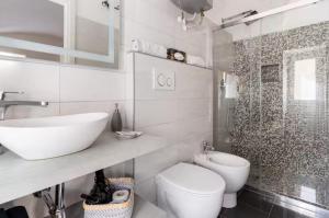 a bathroom with a sink and a toilet and a shower at C’era una Volta in Isolabona