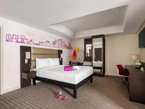 A bed or beds in a room at ibis Styles Sharjah