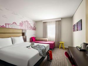 A bed or beds in a room at ibis Styles Sharjah