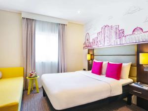 A bed or beds in a room at ibis Styles Sharjah