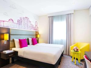 A bed or beds in a room at ibis Styles Sharjah