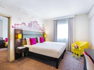 A bed or beds in a room at ibis Styles Sharjah