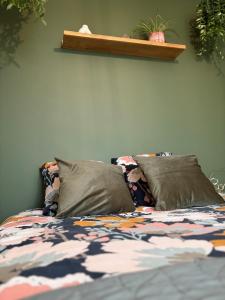 a bed with two pillows on top of it at Maison paisible in Niort