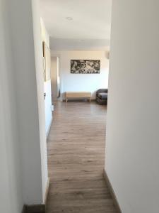 a hallway with a living room with a couch at La Esencia de Delicias in Zaragoza