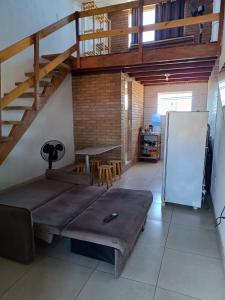 a room with a bed and a table and stairs at Apartamento completo in Prado