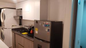 a kitchen with a refrigerator and a stove at Apartment in Envigado with a pool in Envigado +3 photos