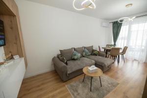 a living room with a couch and a table at Panoramic RESIDENCE in Baia Mare