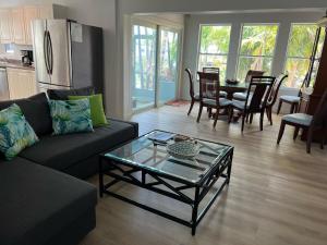 a living room with a couch and a table at Flamingo Palms Cottage in Marathon