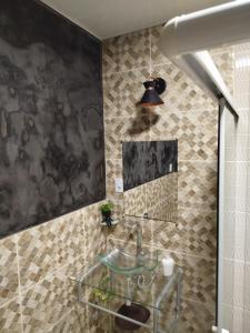 a bathroom with a glass sink and a mirror at Spacious COP 30 home - Casa espaçosa COP 30 in Belém +23 photos