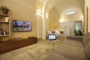 a living room with a couch and a laptop on a table at Bedinle' in Lecce