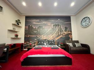 a bedroom with a large painting of a bridge at JohnGold Red Room in Debrecen