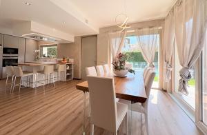 a kitchen and dining room with a table and chairs at Serenity villa - Lake Como in Colico