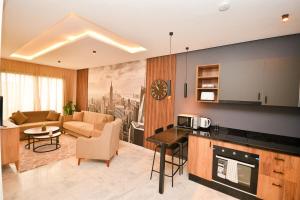 a kitchen and living room with a couch and a table at Atelier Aedes - Studio 15 in Maarif